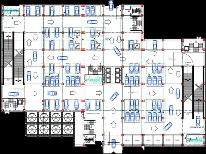 Ground floor parking plan with bays, directional arrows and circulation cores.