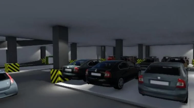 Interior view of the parking deck with columns, hazard-striped kerbs and parked cars.