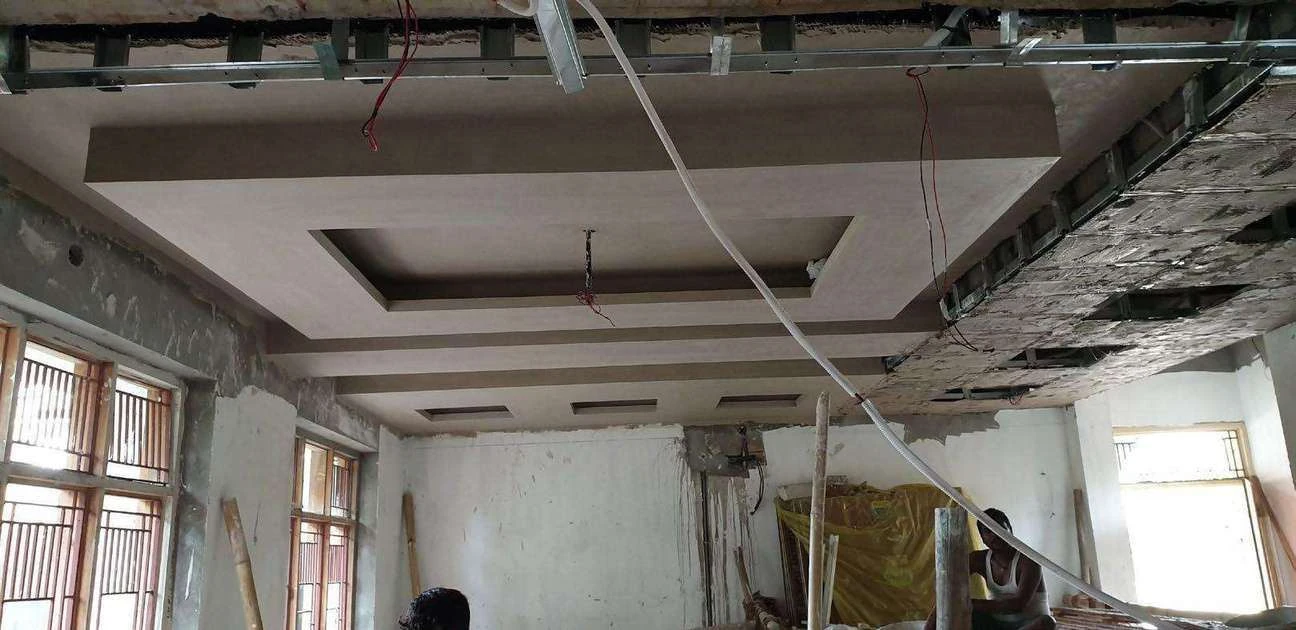 Site photograph of the home office false ceiling framework with services still exposed.