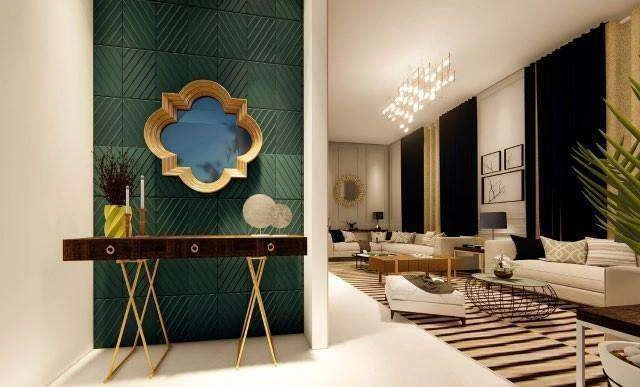 View from the entrance foyer into the living room, the green panel wall in the foreground and the seating beyond.